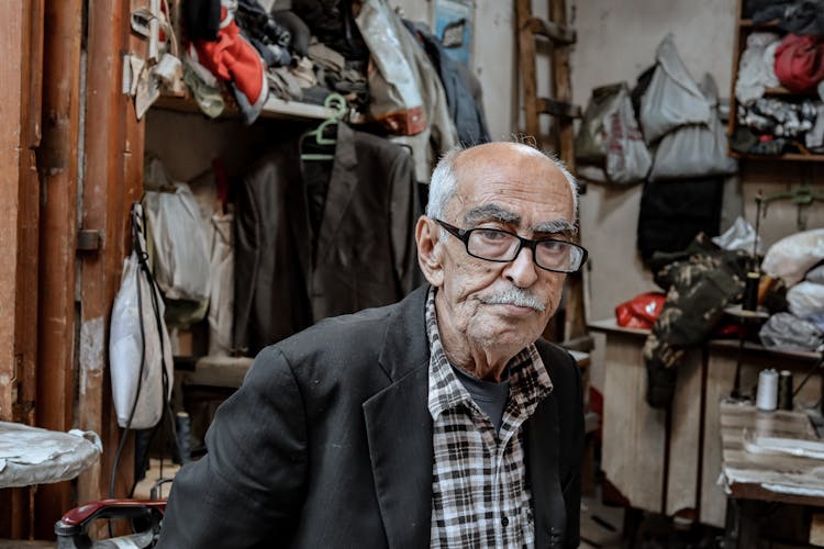 Portrait Of A Senior Man In An Old Fashioned Tailoring Studio