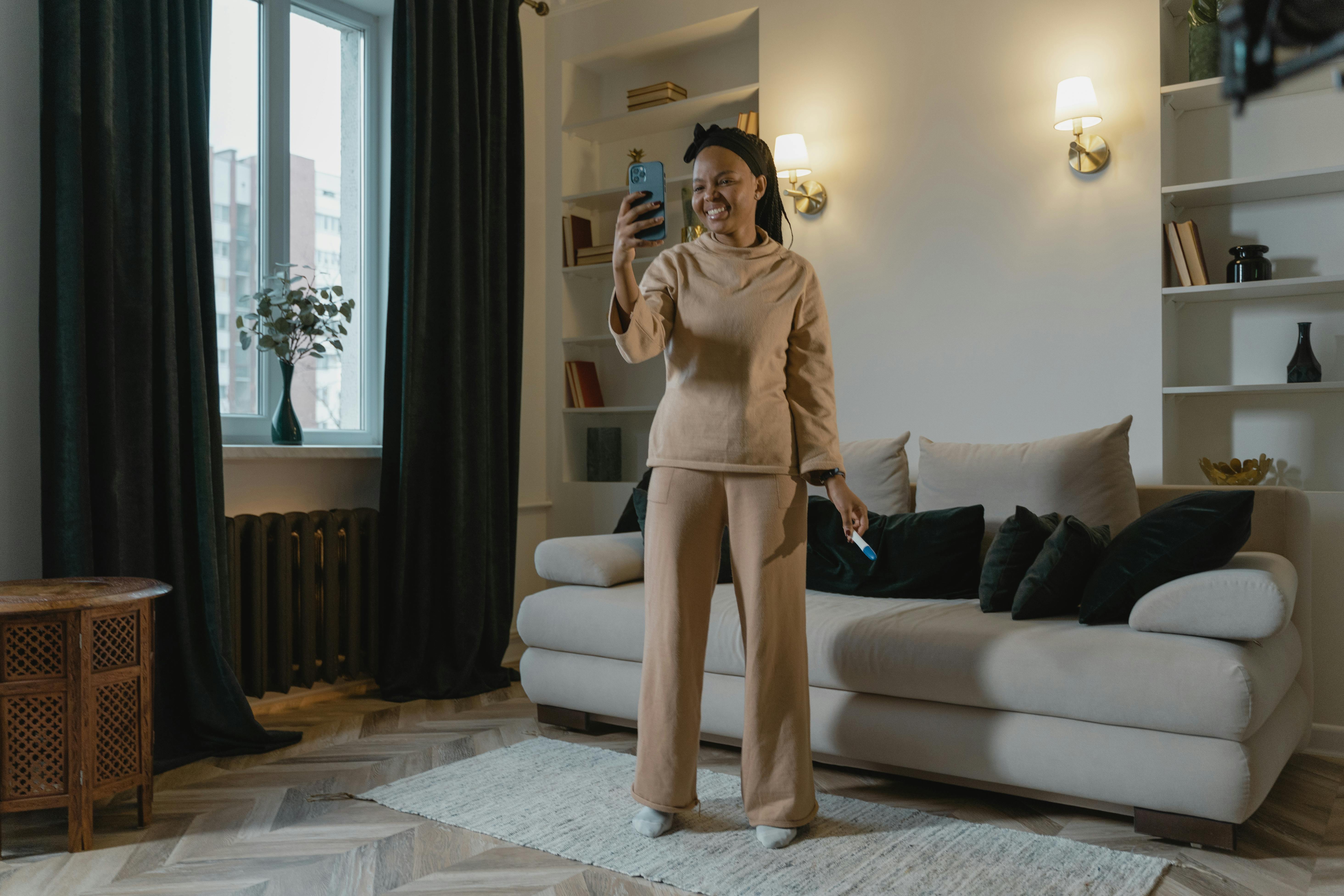 a happy woman video calling in a living room