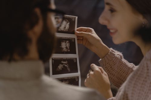 Free A Couple Looking at Ultrasound Picture Stock Photo
