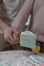 People Holding a Slice of Cake