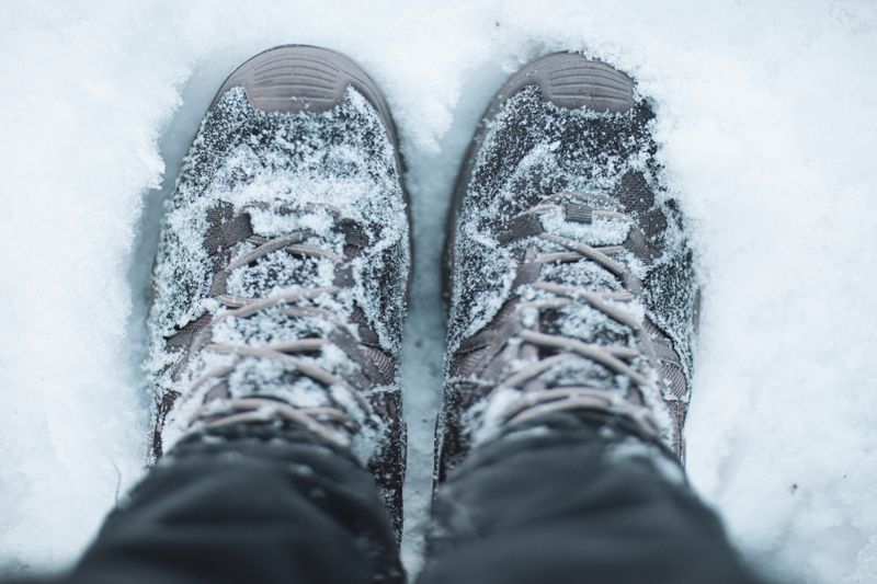 Snow-covered hiking shoes, winter scene