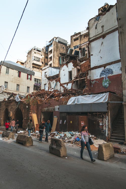 Free People Passing by a Ruined Building in Gemmayzeh, Beirut, Lebanon Stock Photo