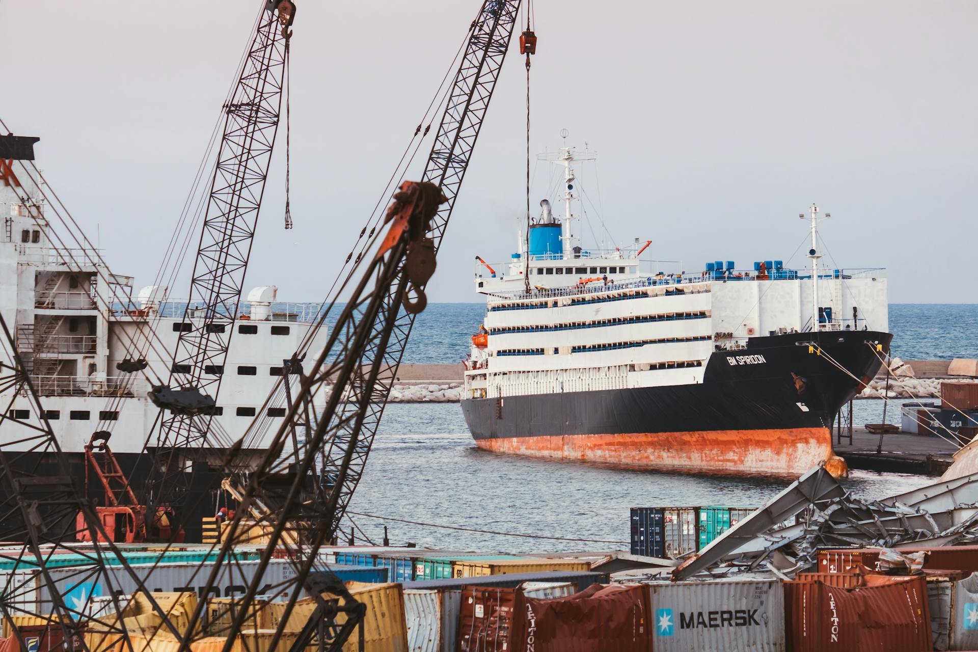 Cargo ships and cranes at Beirut Port showcasing industrial maritime activity with shipping containers.