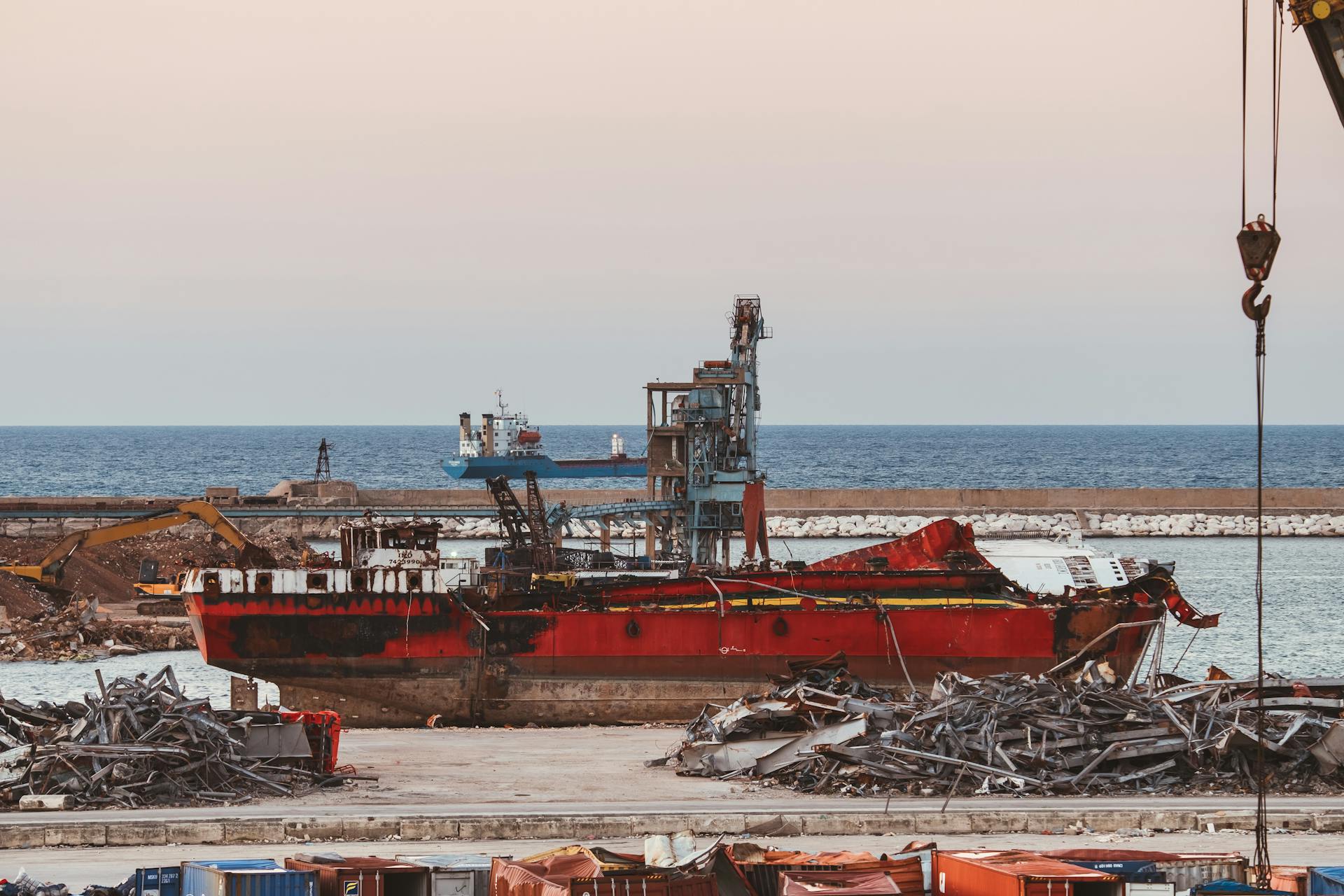 Depicts a destroyed ship and debris at the Port of Beirut, Lebanon.