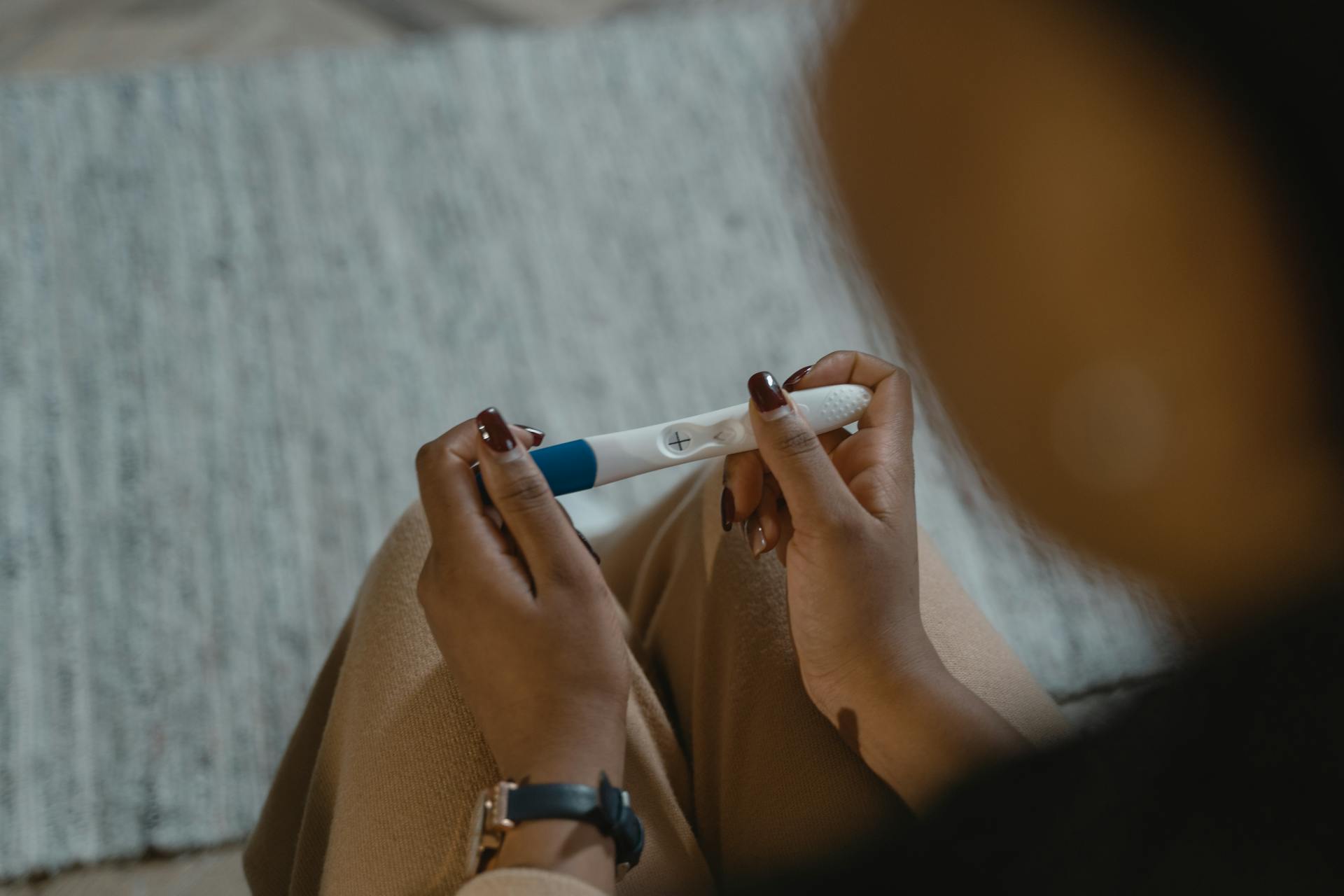 Overhead Shot of a Person Holding a Positive Pregnancy Test