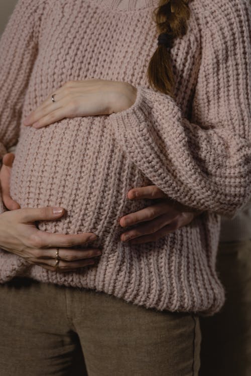 Free Person Hugging A Pregnant Woman in Gray Knitted Sweater Stock Photo