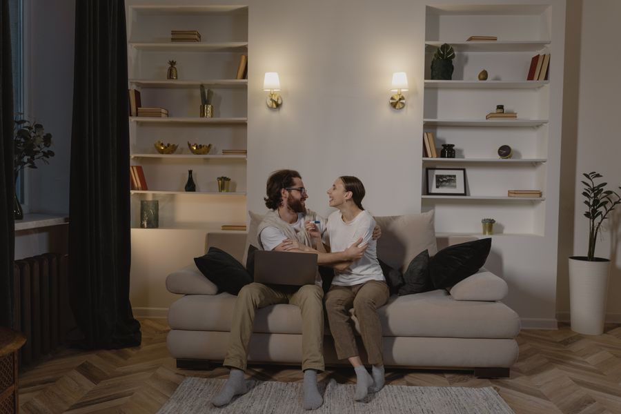 A happy couple admiring their newly installed custom built-in shelving together