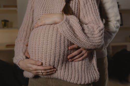 Free Husband Holding Tummy of His Pregnant Wife Stock Photo