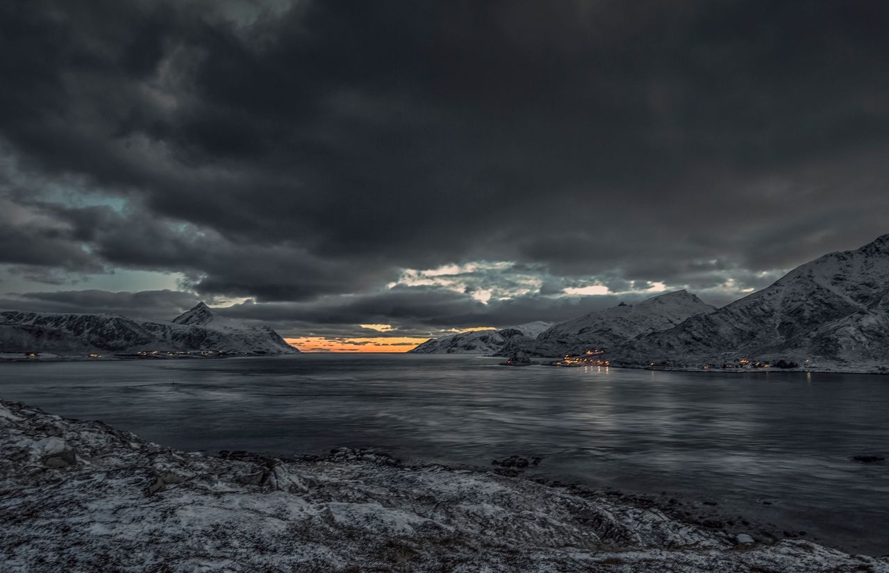 breathtaking view of snow capped mountains under thick clouds showcasi
