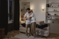 Woman in White Long Sleeve Shirt and Gray Pants Standing Beside Woman in Gray Long Sleeve