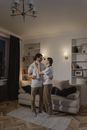 Woman in White Long Sleeve Shirt and Gray Pants Standing Beside Woman in White Long Sleeve