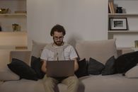 Man in White Crew Neck T-shirt Using Macbook