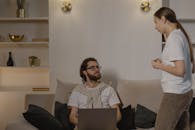 Man in White Shirt Using a Laptop