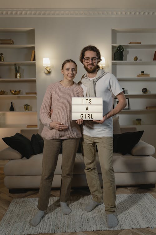 Free A Couple Holding Letterboard with Message while Looking at the Camera Stock Photo