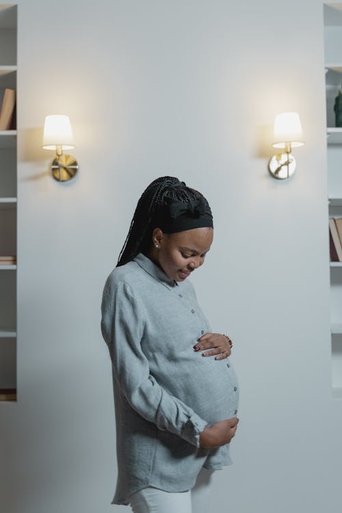Free A Pregnant Woman Wearing Button Down Long Sleeves Stock Photo