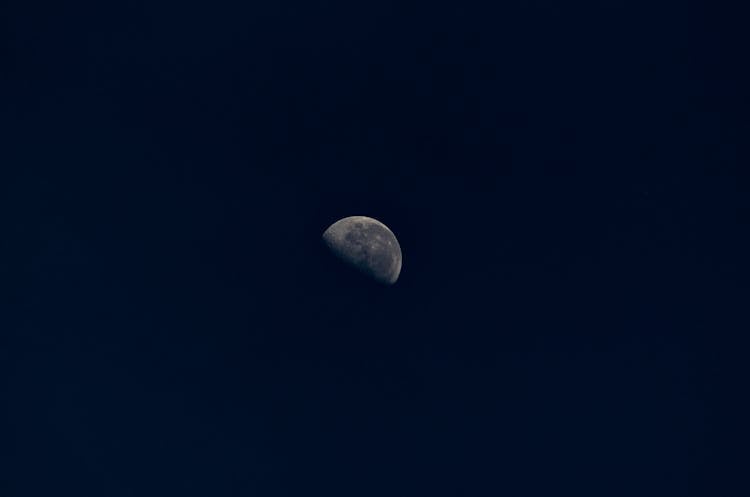 Half Moon With Stains In Black Sky At Night