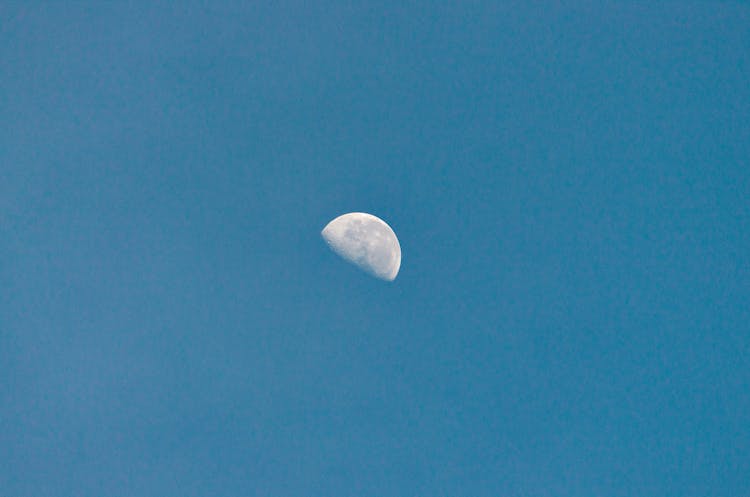 Half Moon With Spots In Blue Sky