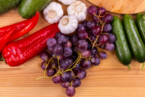 Close-Up Shot of Fresh Vegetables and Fruits on a Wooden Table