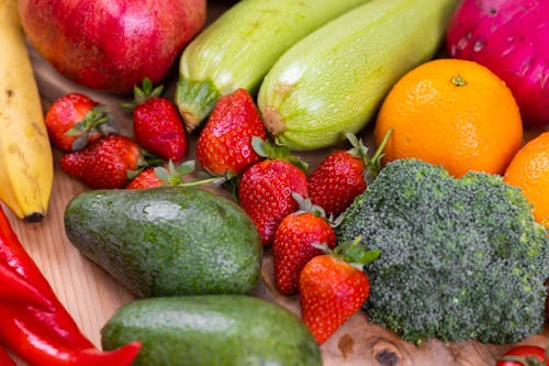 Close-Up Shot of Fresh Vegetables and Fruits on a Wooden Table