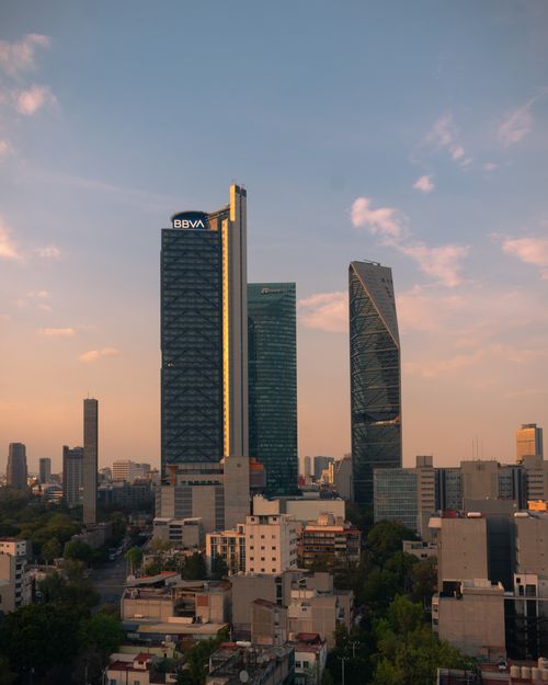 Free Stunning view of high-rise buildings in Ciudad de México at sunset, featuring Torre Reforma and Torre BBVA. Stock Photo