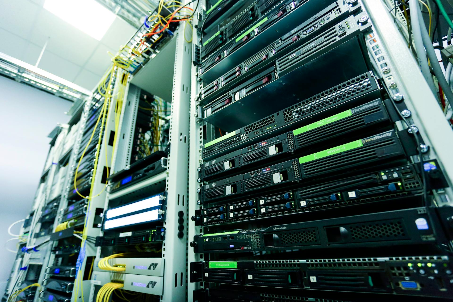 High-tech server rack in a secure data center with network cables and hardware components.