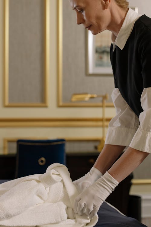 Free A Chambermaid Fixing a Towel in a Room Stock Photo