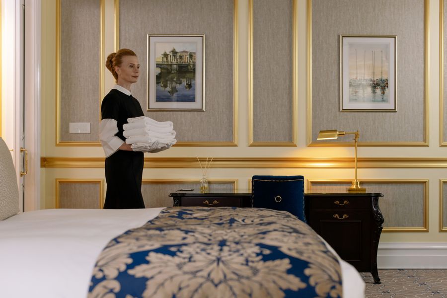 Stack of fresh hotel-white towels and bedding