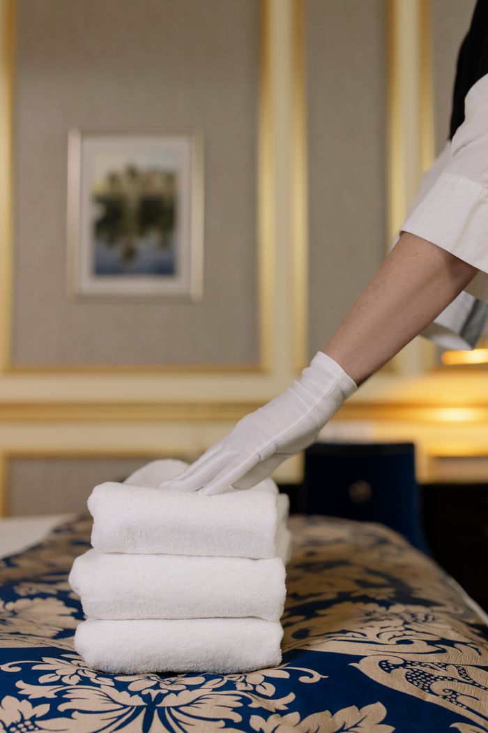 Fresh white towels folded on a bed