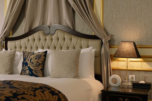 Free Stylish and cozy bedroom featuring elegant design with plush pillows and decorative details. Stock Photo