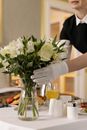Woman Arranging Flowers in a Glass Vase