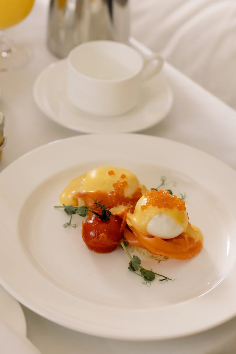 Delicious Breakfast Poached Eggs And Salmon With Caviar On White Ceramic Plate 