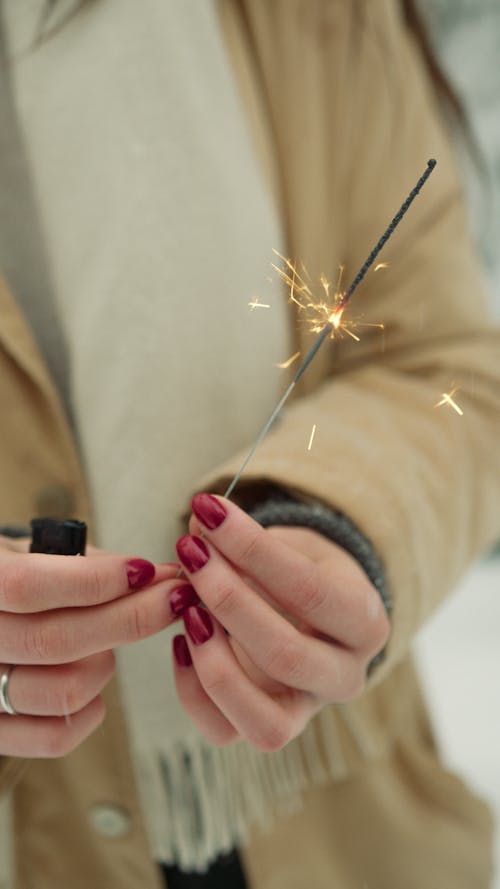 Woman Holding a Lighted Sparkler