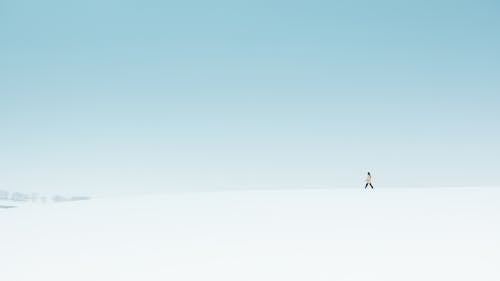 Person Waking on Snow Covered Ground