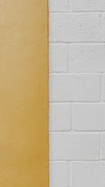 A close-up of a minimalist, dual-toned wall showcasing a smooth and textured surface.