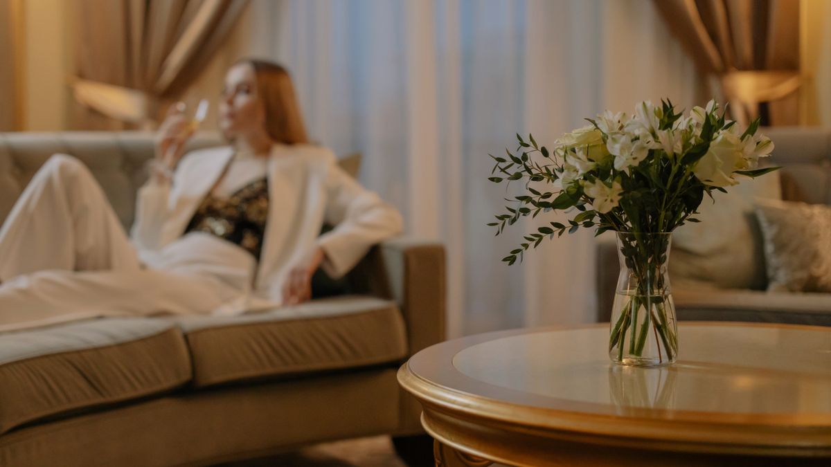 A bright hotel room made up and ready for a guest