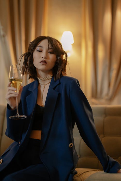 Woman in Blue Blazer Holding a Glass of Wine