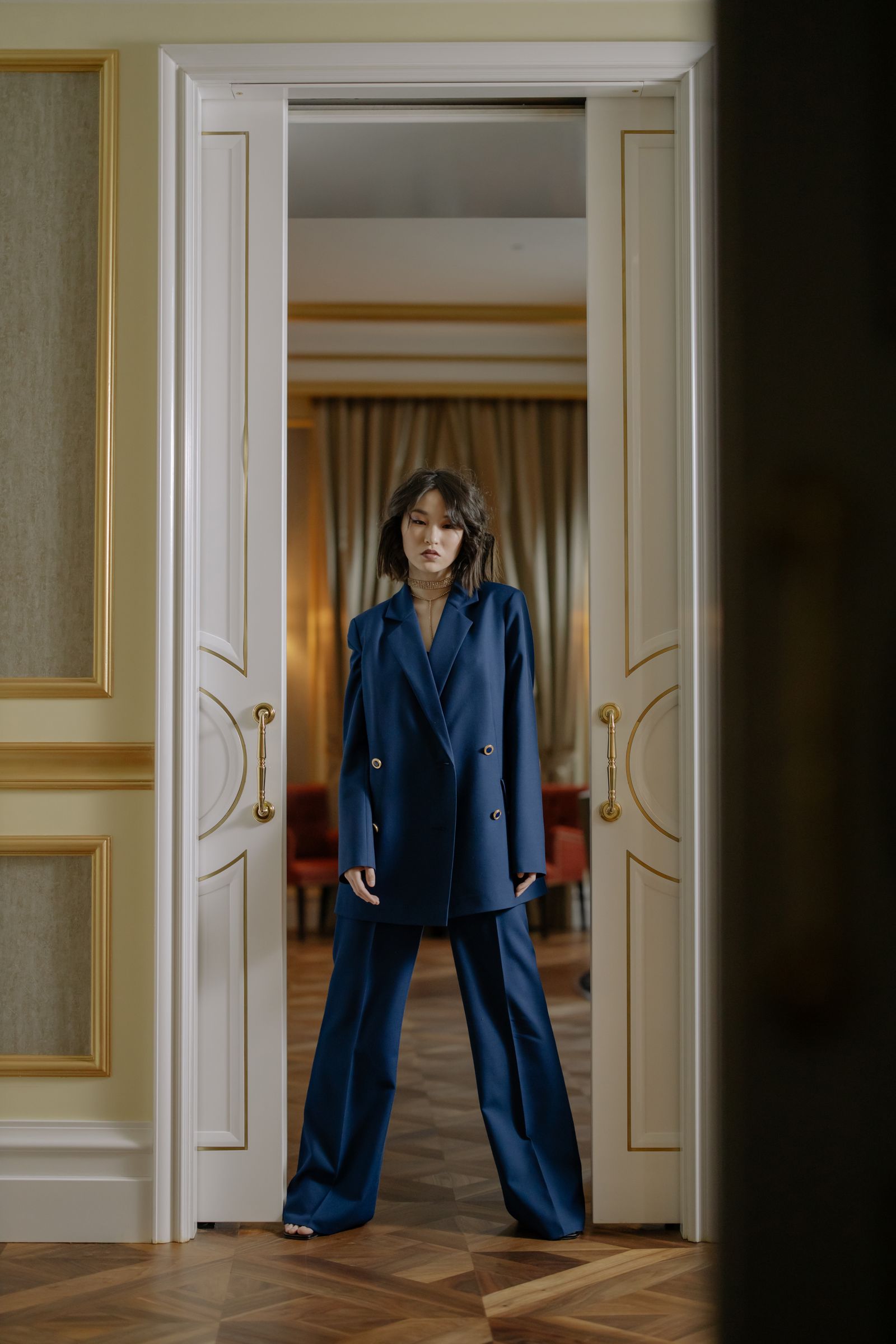 A pretty woman in a blue blazer and tailored trousers