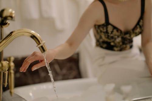 Free A Golden Faucet with Running Water Stock Photo