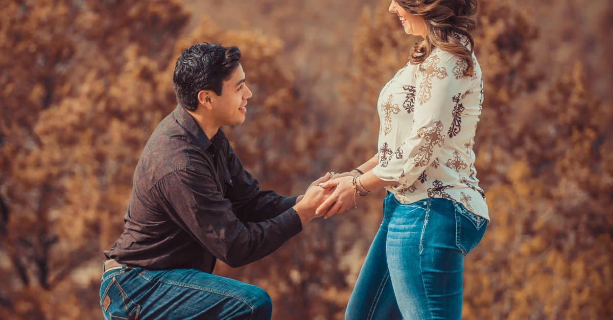 Proposing Position A Man Kneeling while Proposing to Her Partner · Free Stock Photo