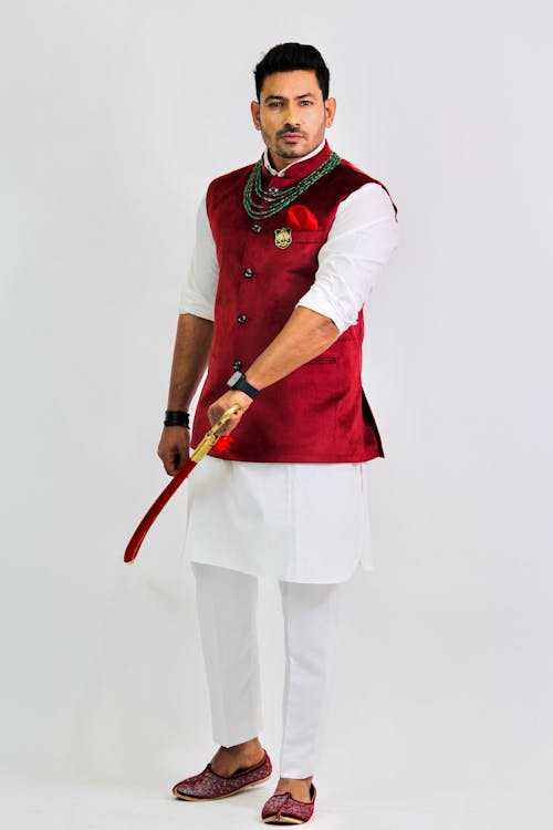 Free A Man Wearing a Costume while Holding a Sword Stock Photo