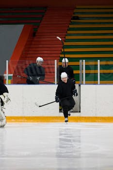 A team of ice hockey players entering the rink, ready to play a match indoors.