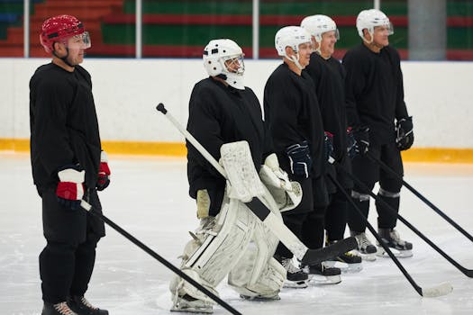 A team of adult male hockey players in uniforms standing on an ice rink indoors.