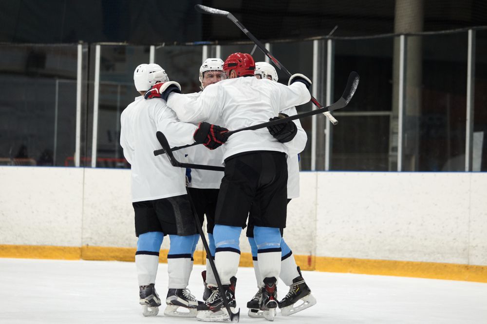 Ironvale players celebrating a goal on the ice