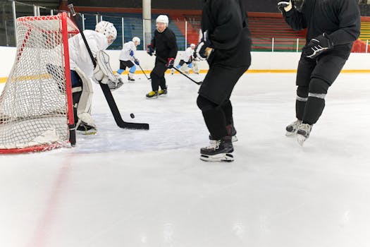 Intense ice hockey match with players in action on the ice rink, showcasing a goalie block.