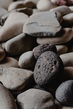 Close-up image of textured river stones with natural patterns, showcasing earthy tones and textures.