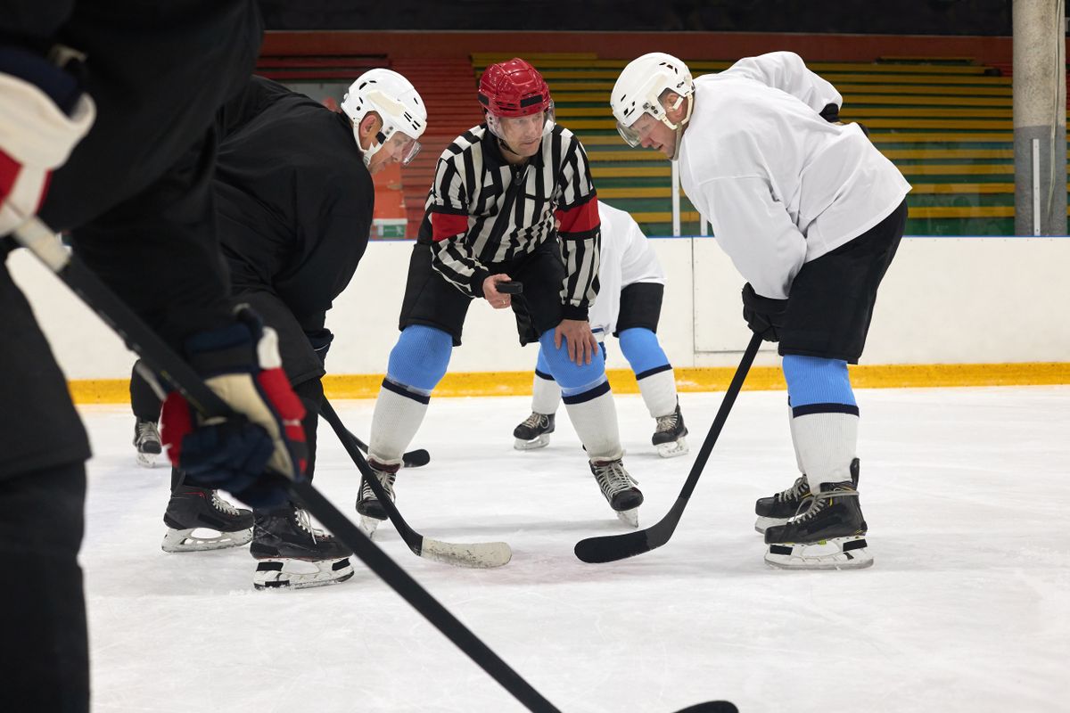Hockey players contesting a faceoff