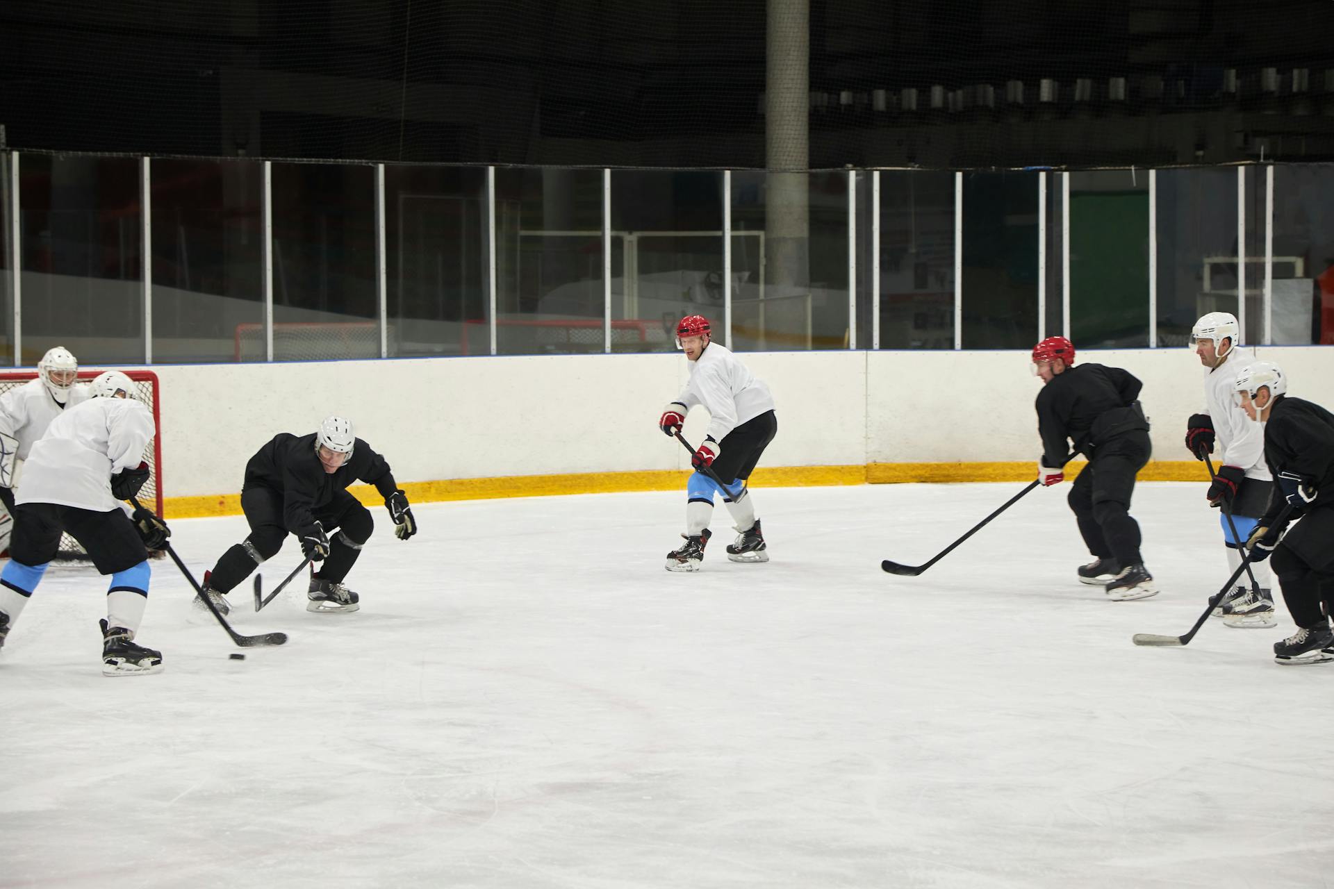 Ice hockey team training on the ice rink, showcasing skill and teamwork in a sports stadium.