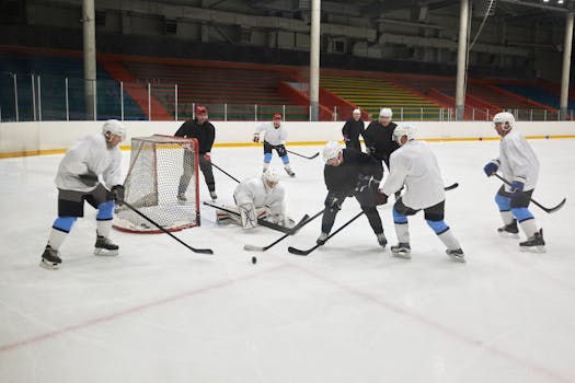 Team practicing ice hockey with intense action on the rink.
