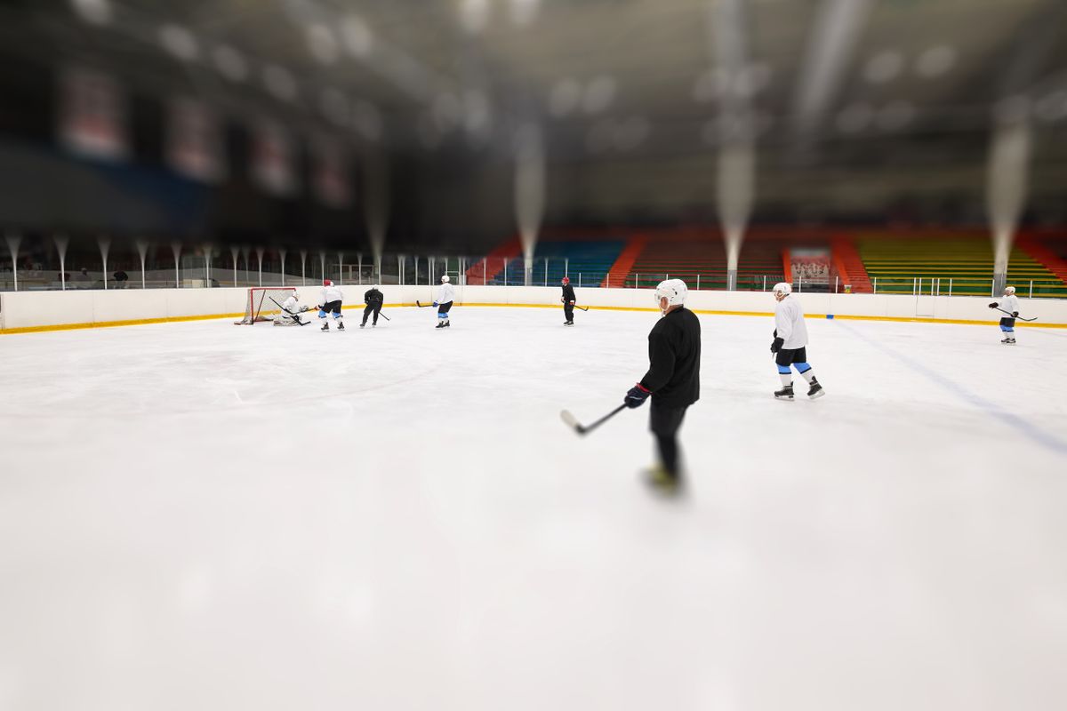 Hockey players practising on an indoor ice rink