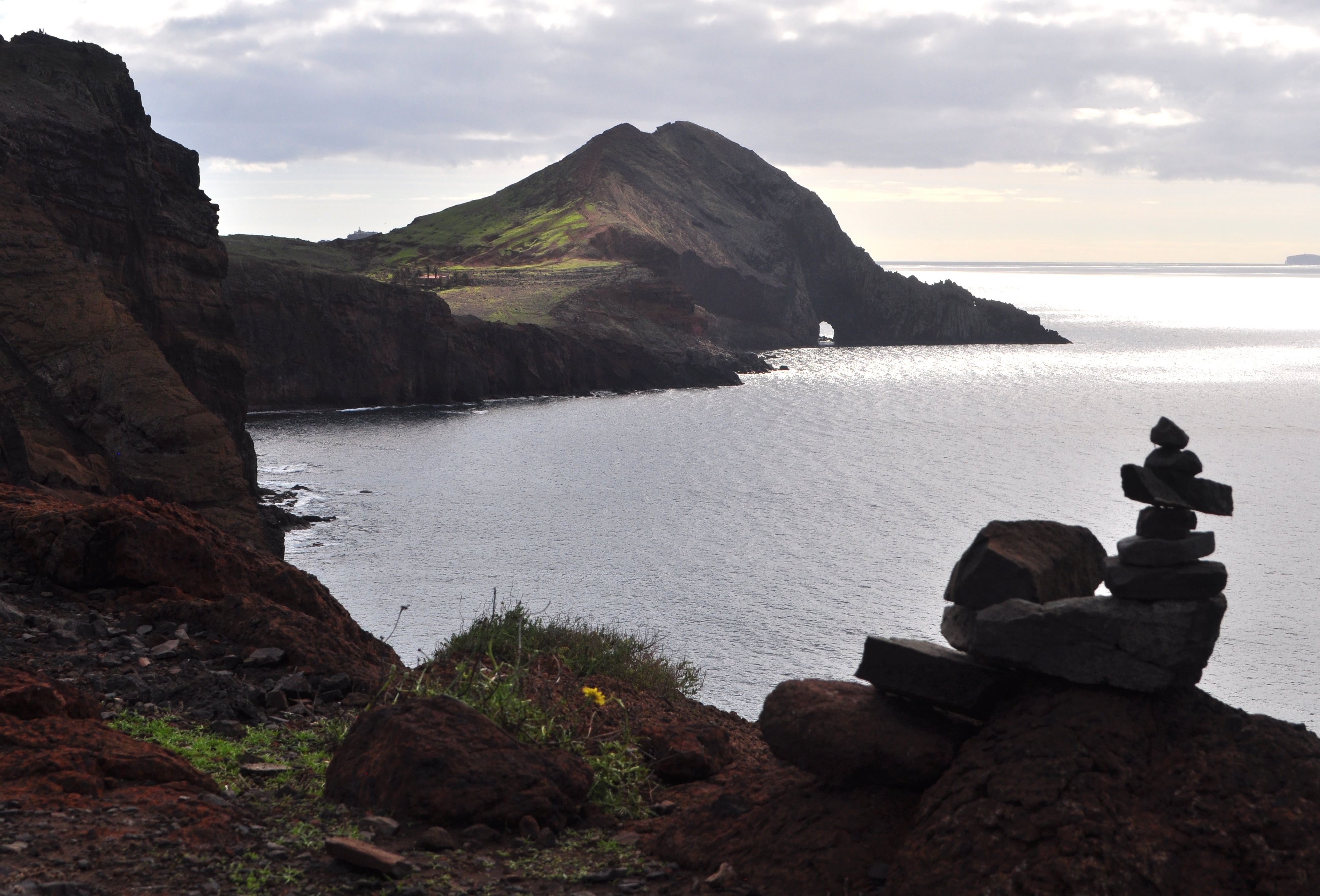 Serene rocky coast of Ponta de Sao Lourenco, Madeira, with stacked stones and ocean backdrop.